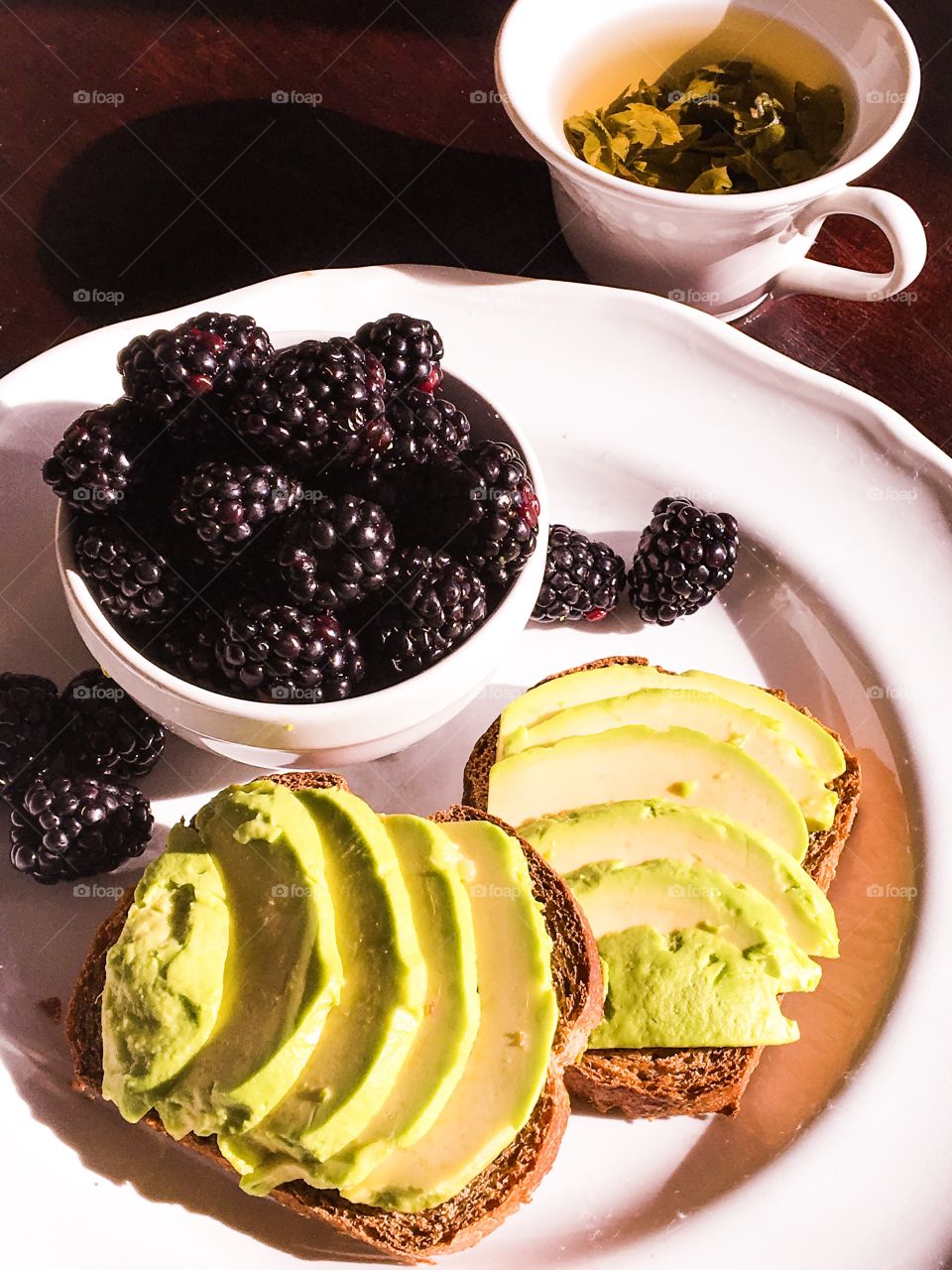 Avocado toast with blackberries and green tea