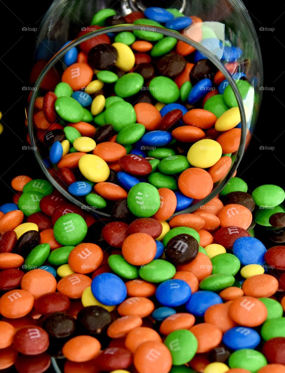 M&Ms spilling out of a glass