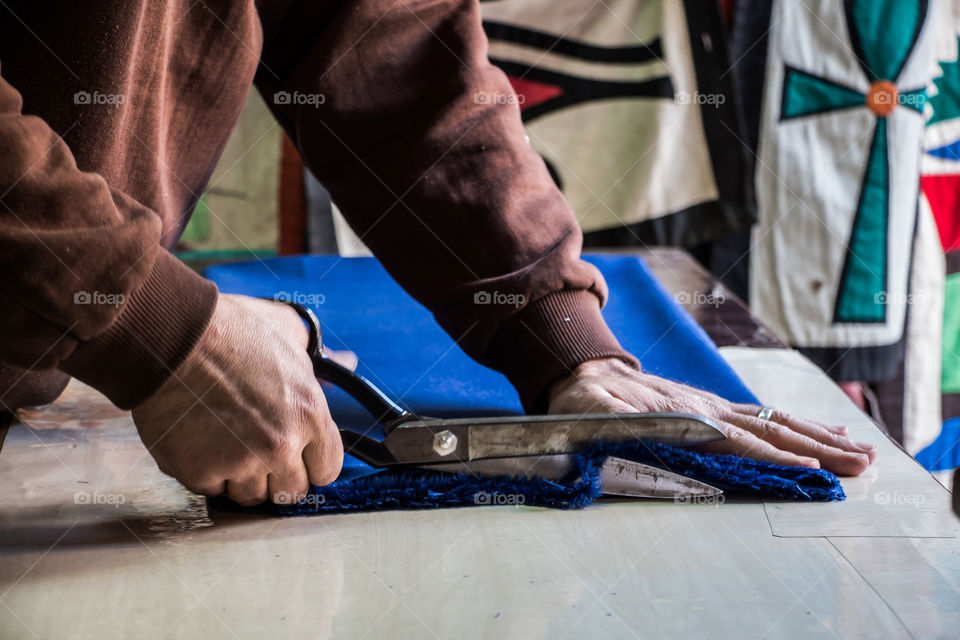 Staying in his own shop cutting this textile and taking measurements. I posted different stages. I was lucky to get there while he was just starting.