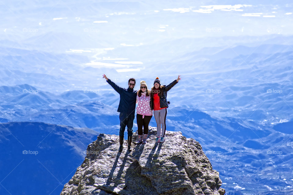 Group of friends over mountain top in Calar Alto Observatory, Spain.