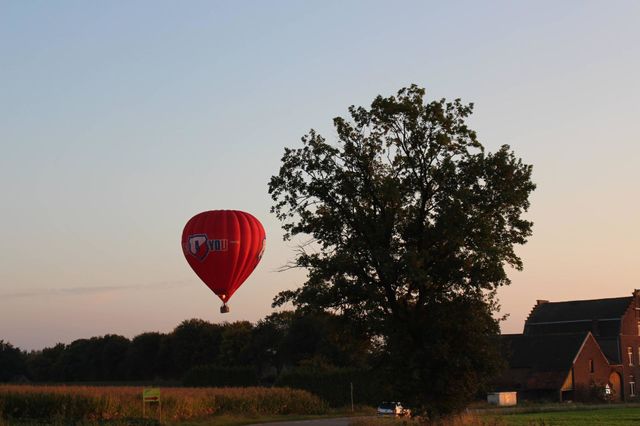 Hot air balloon flying over the houses