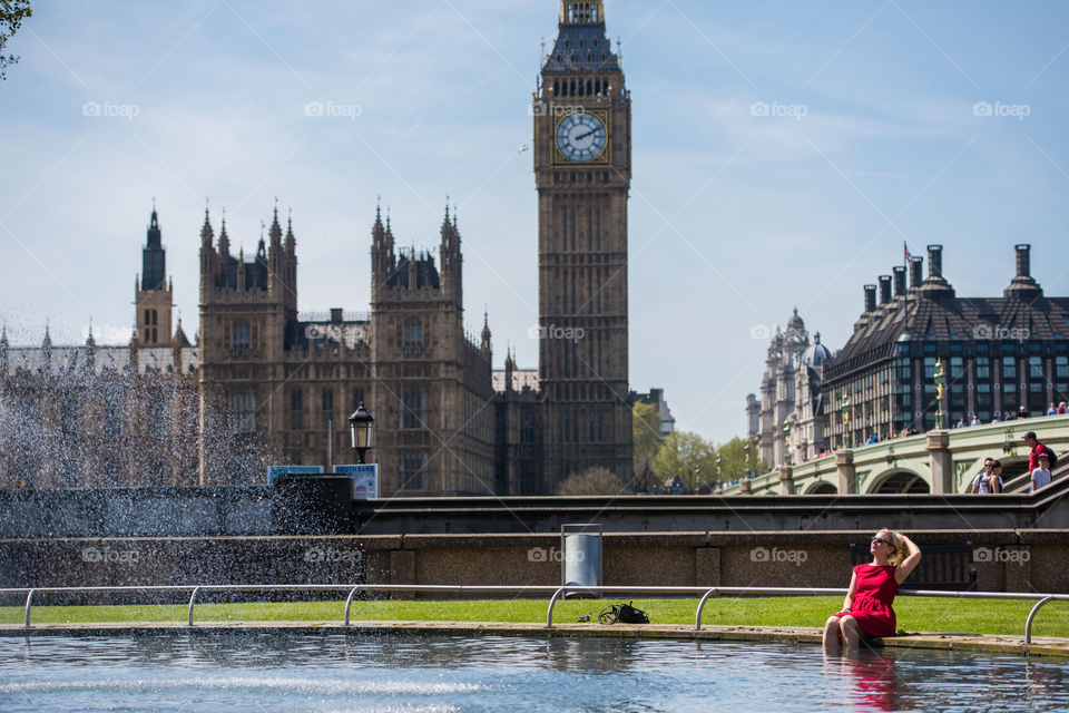 Woman sitting near Big Ben Clock Tower, London