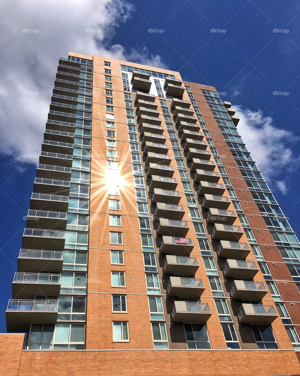 Apartment building with flag and lens flare