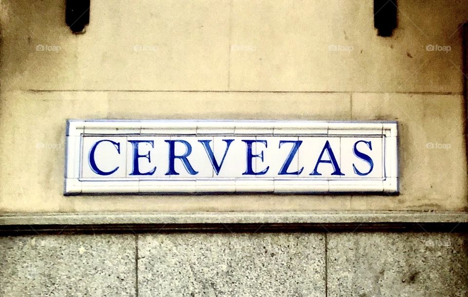 Trip to Europe. Sign on the side of a building, visible from the streets, denoting a licensed establishment, as Cerveza means beer. 