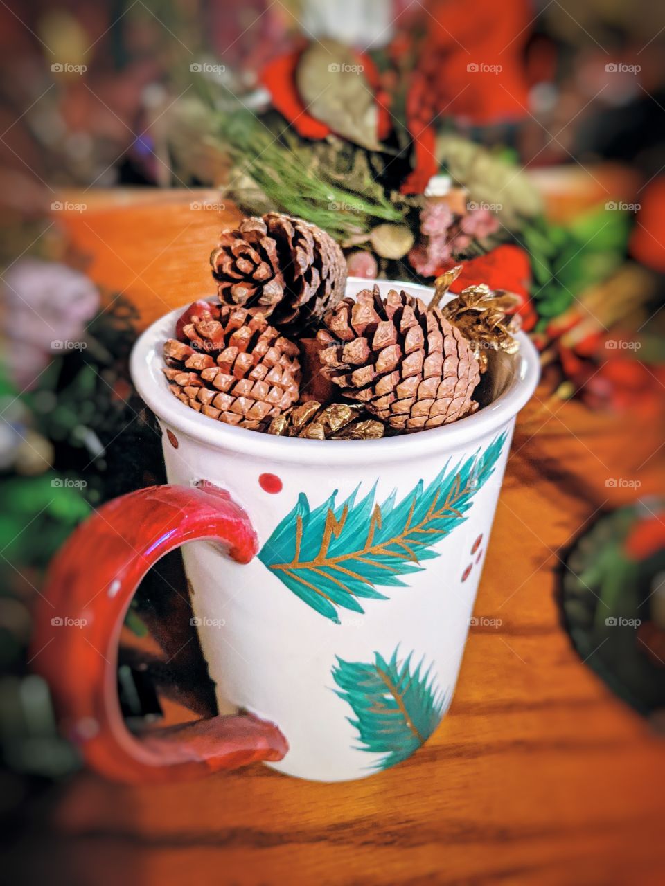 Festive Holiday mug filled with pine cones