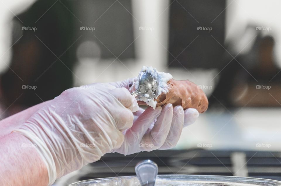 Hands making cannoli with chocolate chips