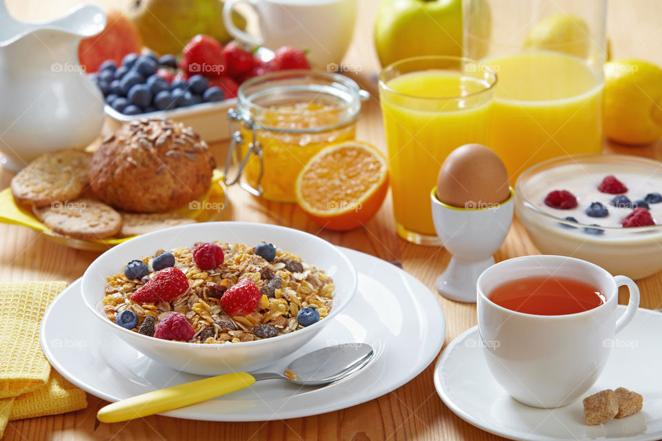Breakfast with cereals, eggs, tea and orange juice is exactly what you need