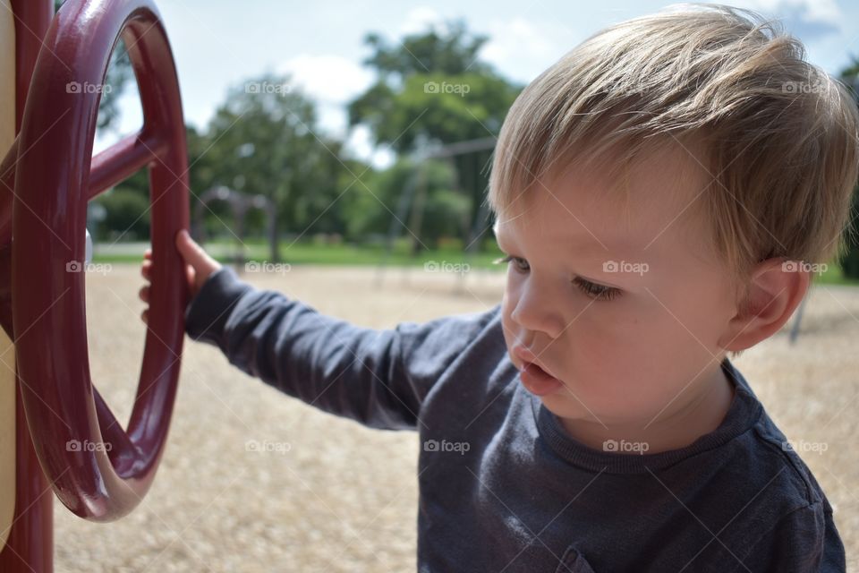 Cute baby boy playing at playground 