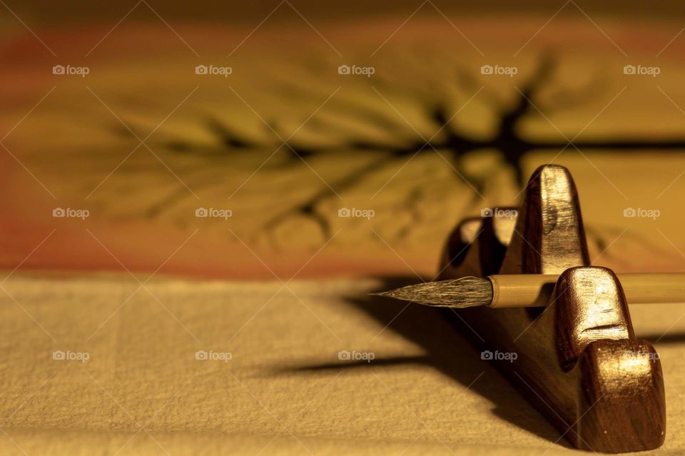 Foap, Art of Composition. Artwork of a tree using watercolor and India ink. Closeup of a Chinese calligraphy brush resting on a hardwood holder. 