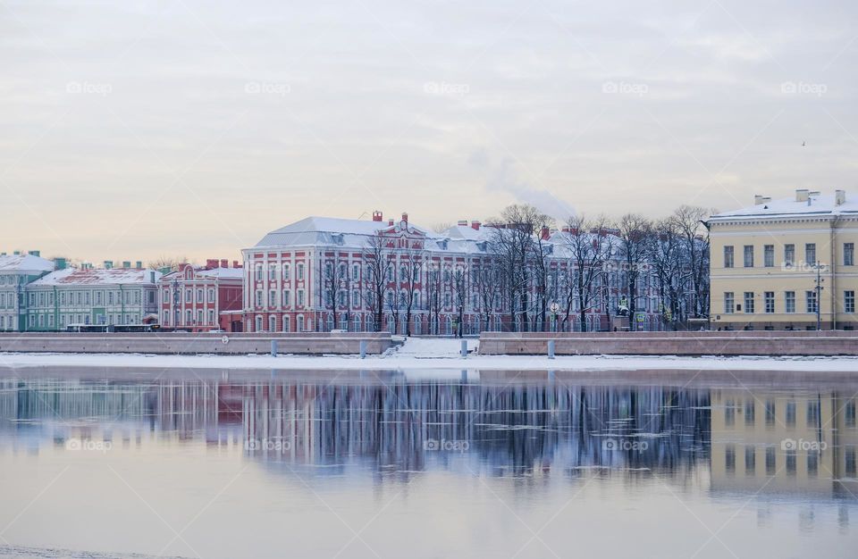 Reflections of buildings in the river in the winter city