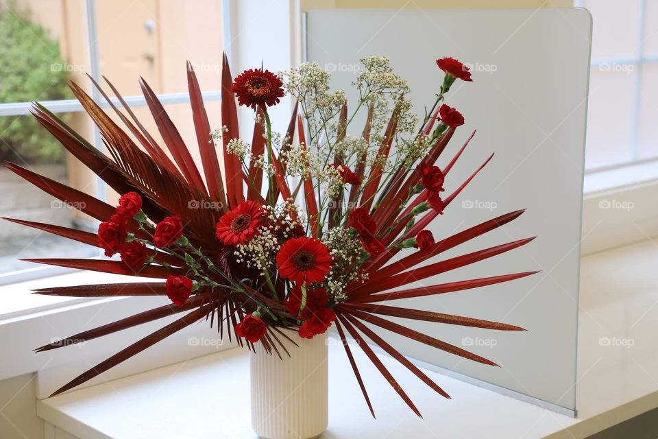 Red flowers in a white vase