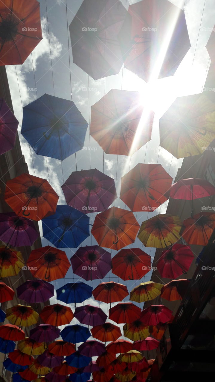 colourful umbrellas hanging up at shopping centre in  bath