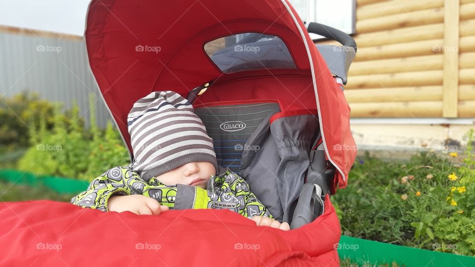 The baby is sleeping in a stroller