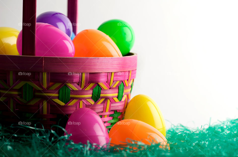 Easter basket overflowing with colored eggs