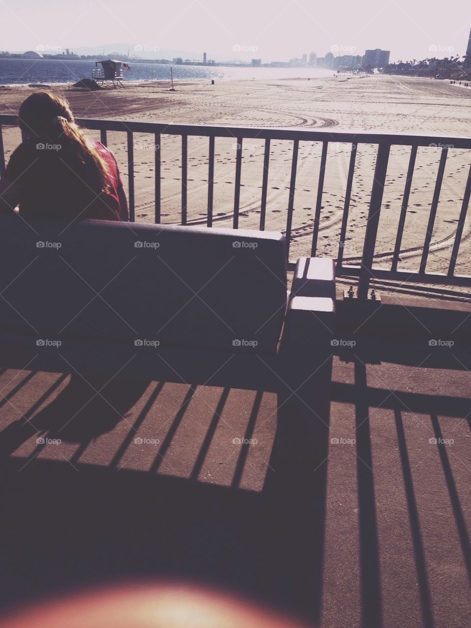 Woman on bench on pier