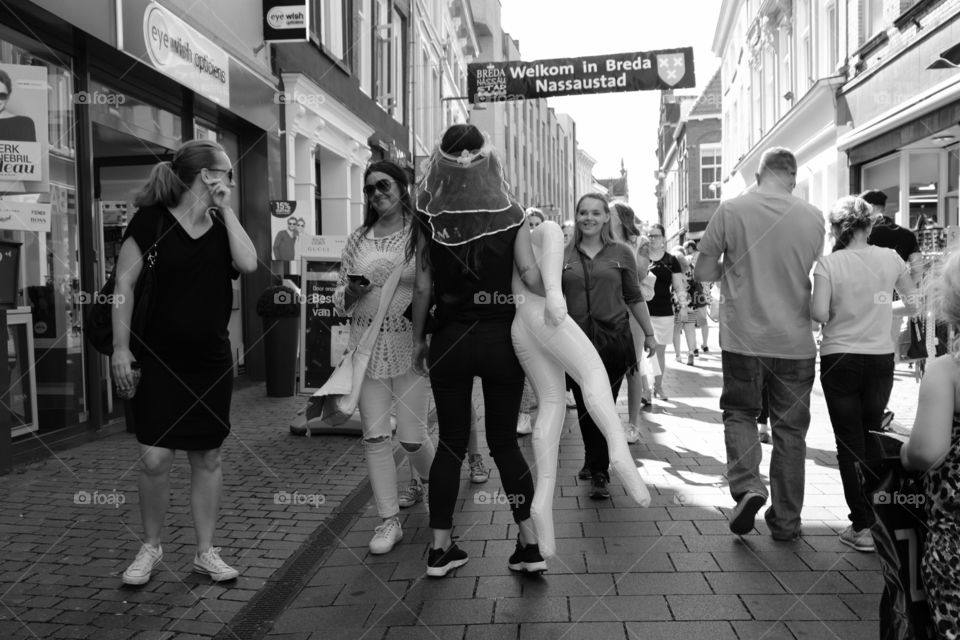 Street photo of people and  dummy in Breda, Holland. Black and white image