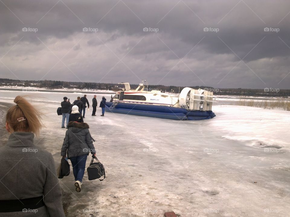 Crossing the river in winter. Boat air padushku.