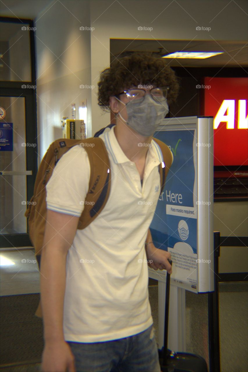 Young Millennial Man Waiting at the Ticket Counter to Board Flight