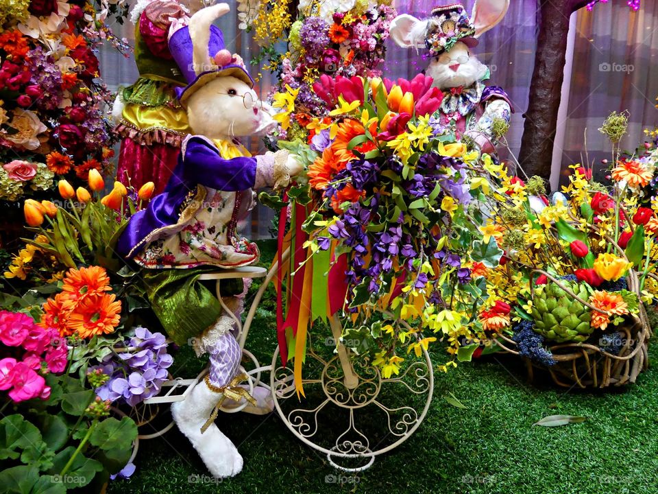 This is spring - HAPPY EASTER - Easter rabbits surrounded by colorful flowers. The exact origins of this mythical mammal are unclear, but rabbits, known to be prolific procreators, are an ancient symbol of fertility.