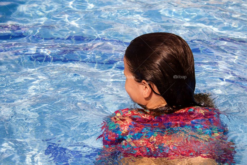 Child enjoying summer in swimming pool