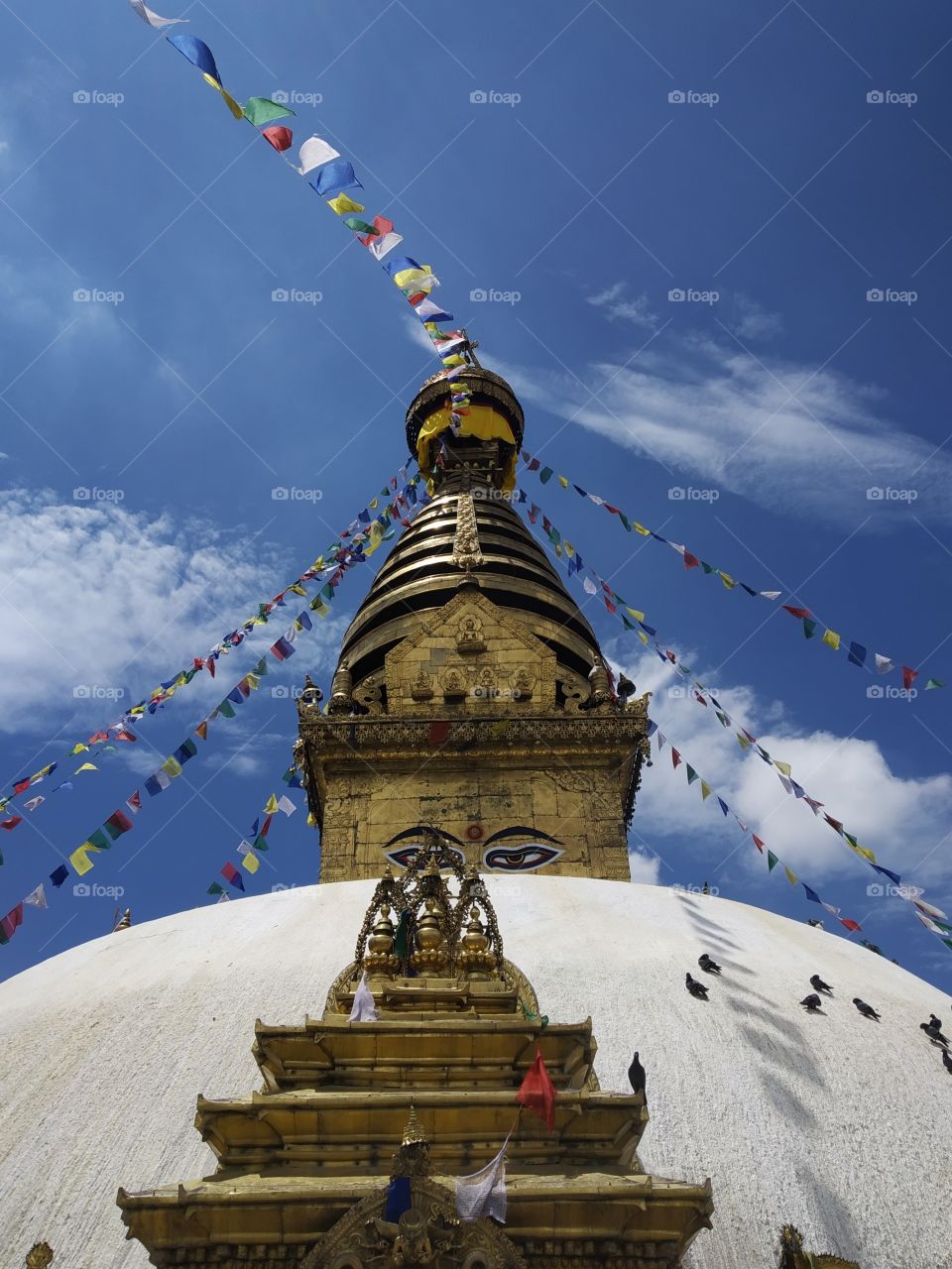 The pick of the stupa is trying to sky and clouds. In fact the stupa represent peace. Those are Buddha eyes and it represents wisdom & compassion