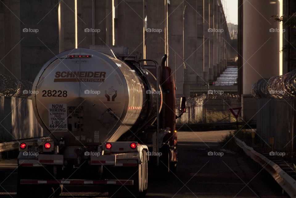 A tanker truck passes by on its way to a shipping complex.