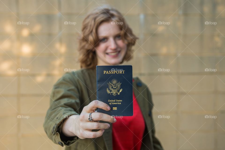 Smiling girl holding USA passport