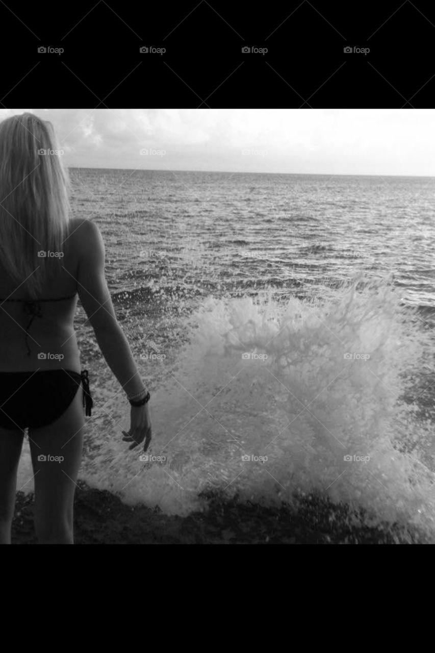 crashing waves on blonde girl