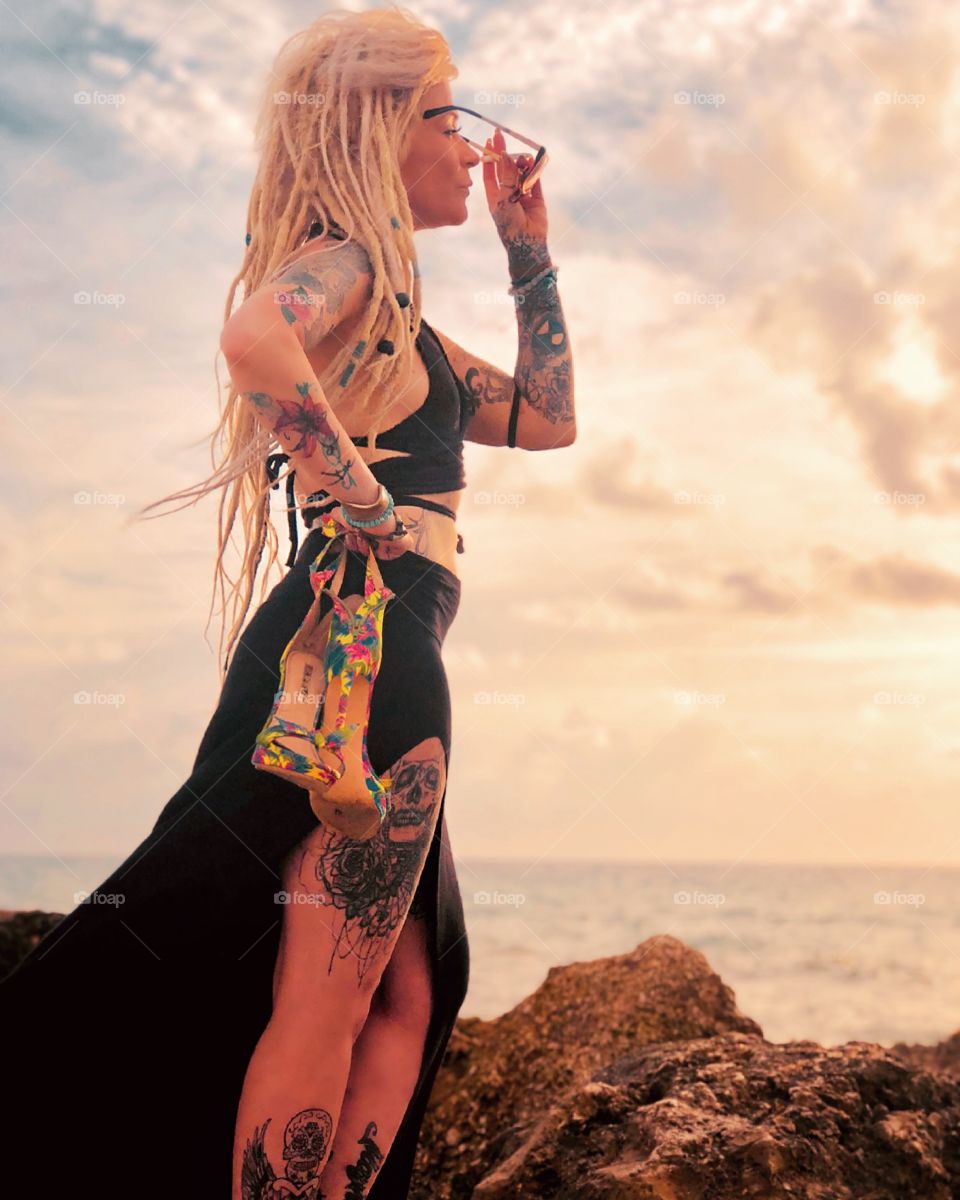 Portrait of tattooed blonde model at the beach at sunrise 
