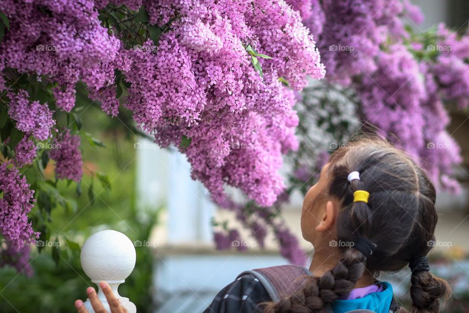 Girl and blooming lilac