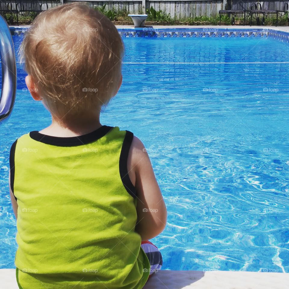pondering the pool. staring out at the pool. he wanted in so badly, but had to wait
