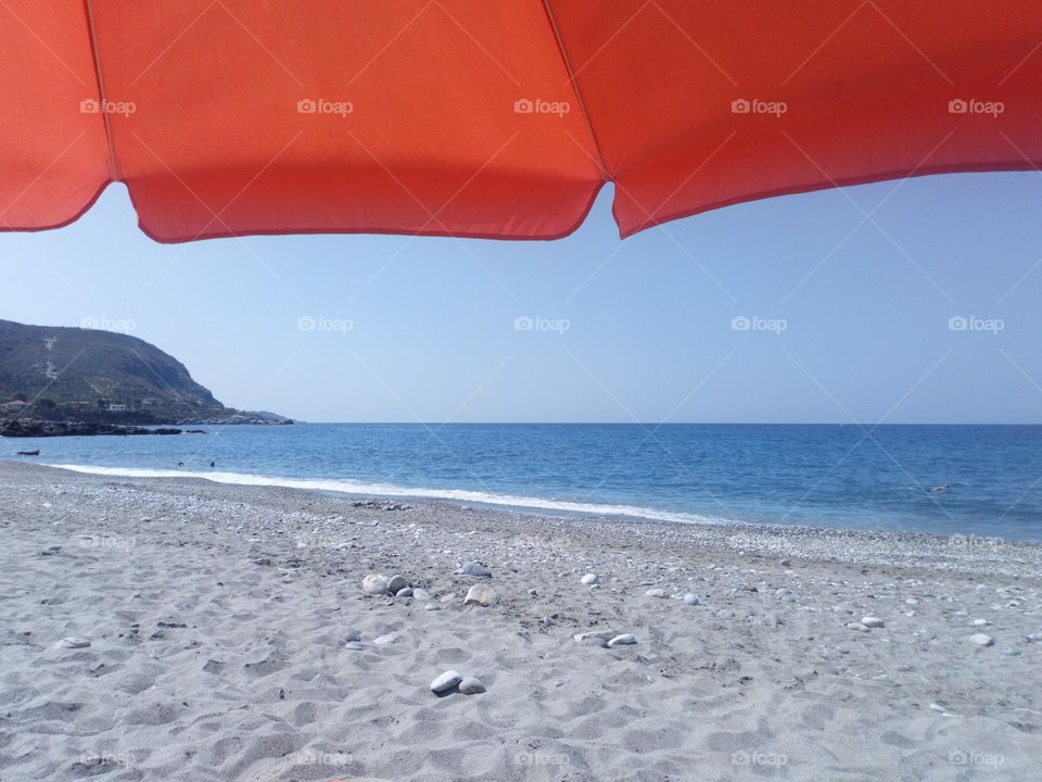 Under an umbrella in the beach!