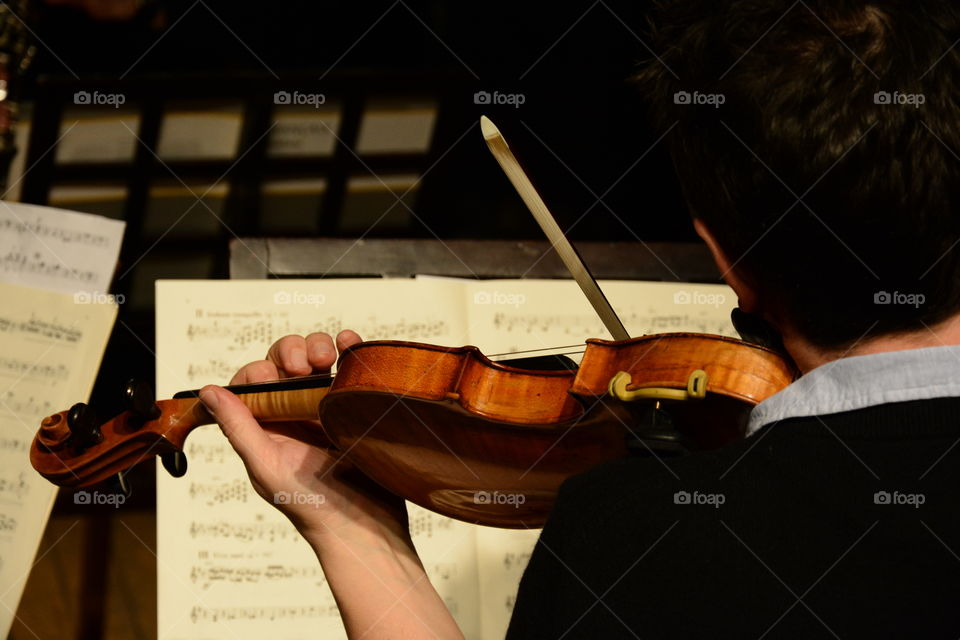 Classical Musician playing the Violin and reading music notes