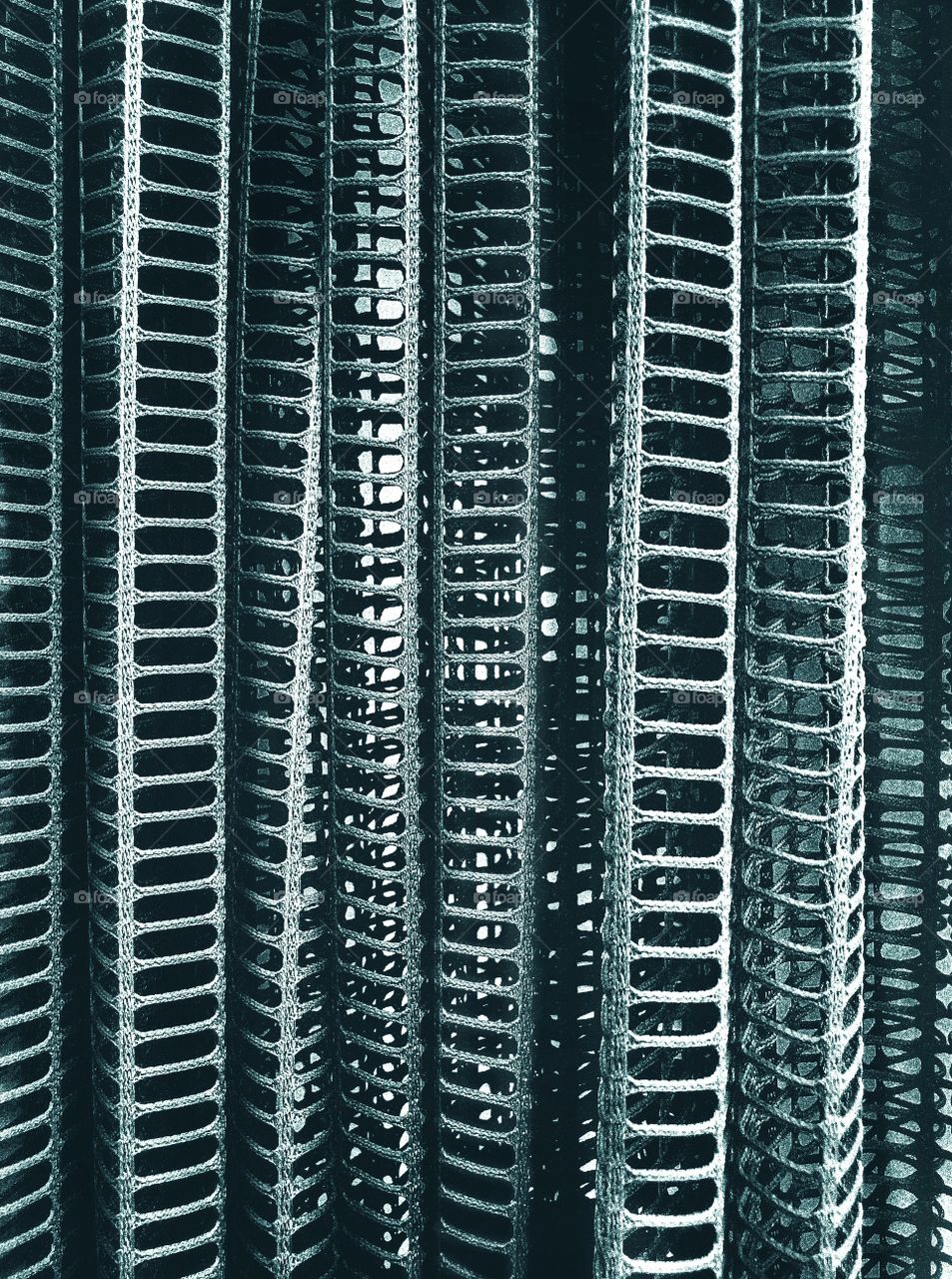 Structure and texture revealed in a close-up of a hanging curtain