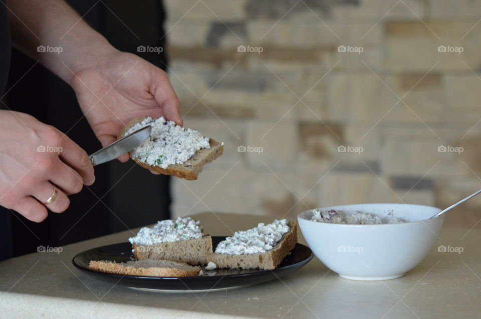 Healthy breakfast- white cottage cheese with onions, chives, salt and pepper on bread