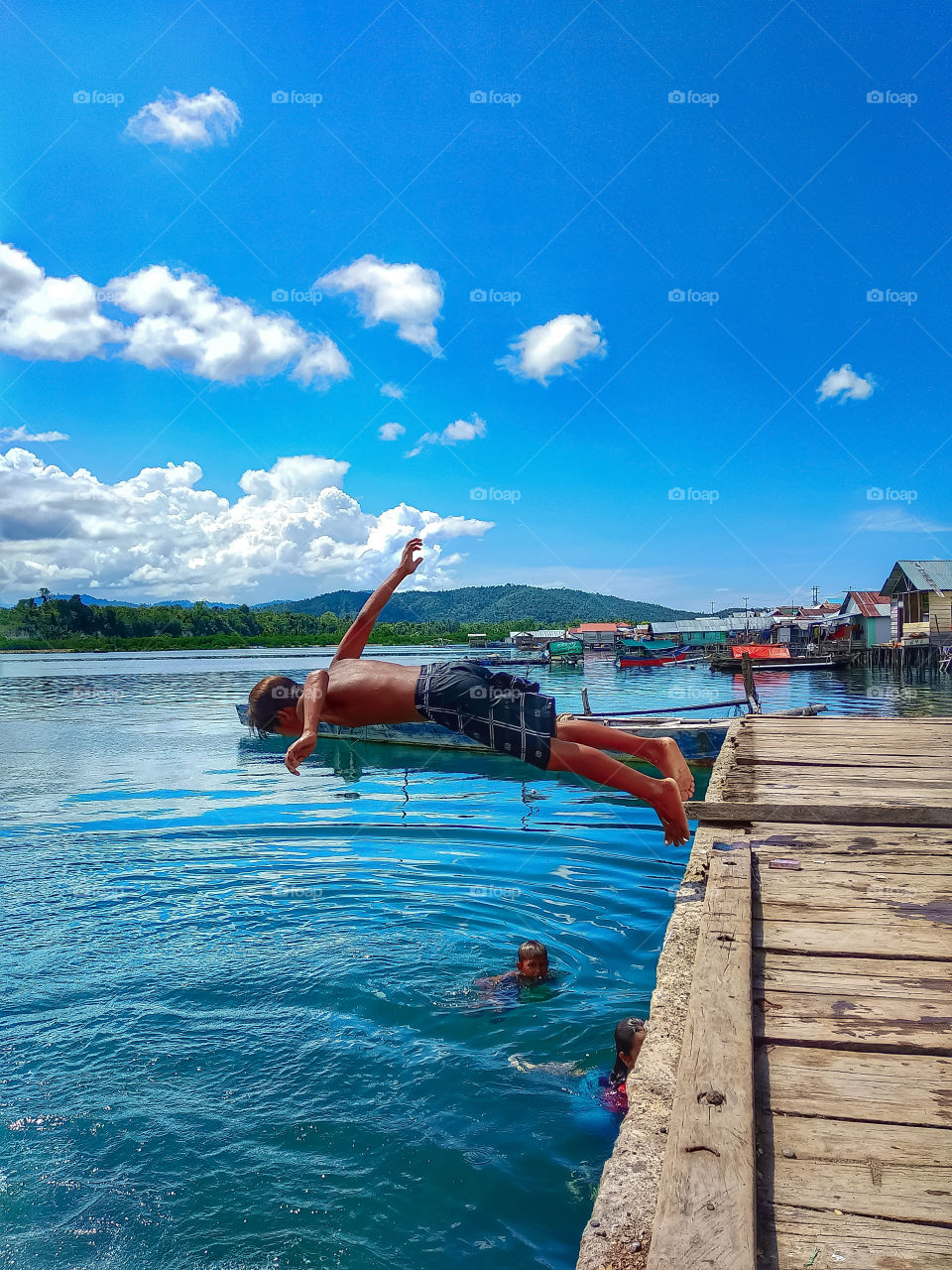 a child playing jumping into the sea