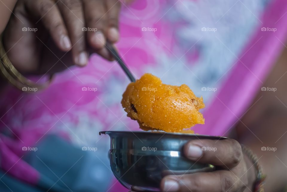 Woman holding dessert in spoon