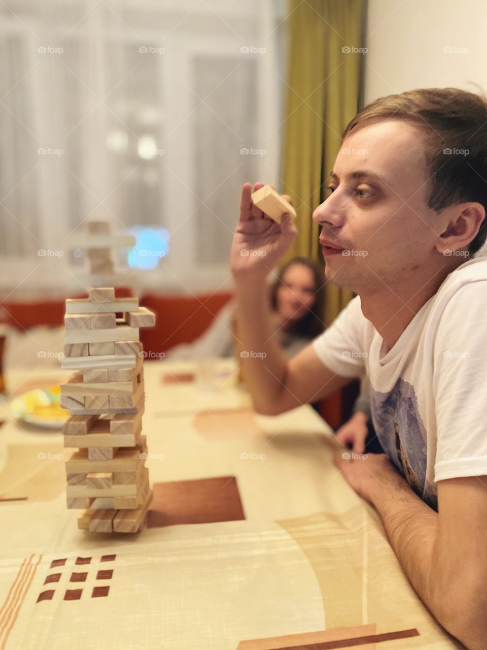 Man playing home game Jenga