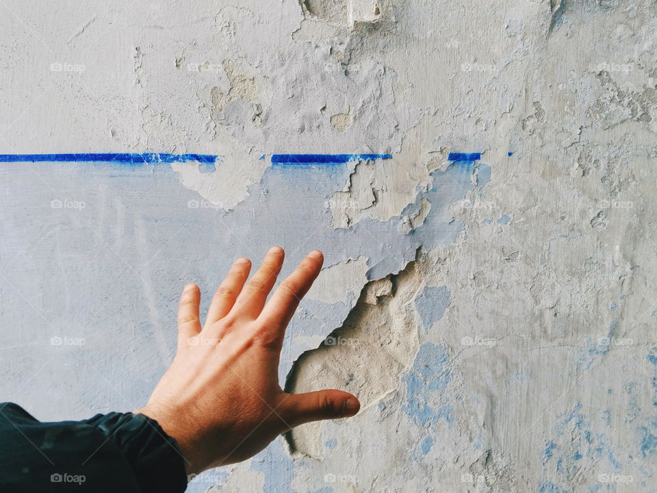 man's hand on a white background dirty old wall