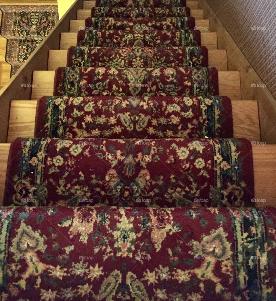 We’re going down a staircase with a red traditional rug