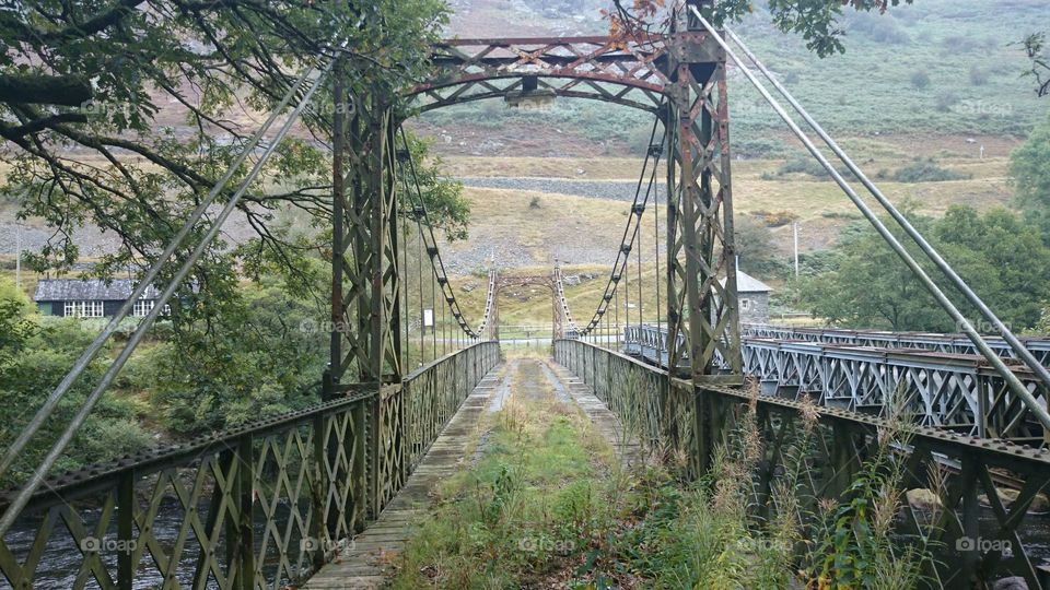 Abandoned Bridge. A disused bridge crossing a river in Wales. 