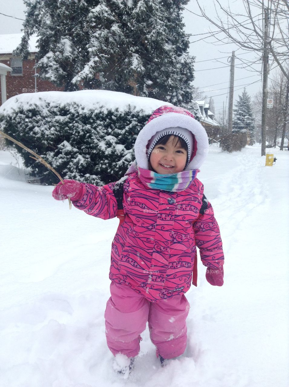 Cute girl standing in snowy landscape