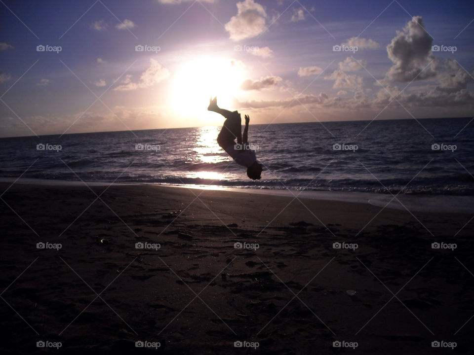 ocean sunrise jump seashore by sergioesteban