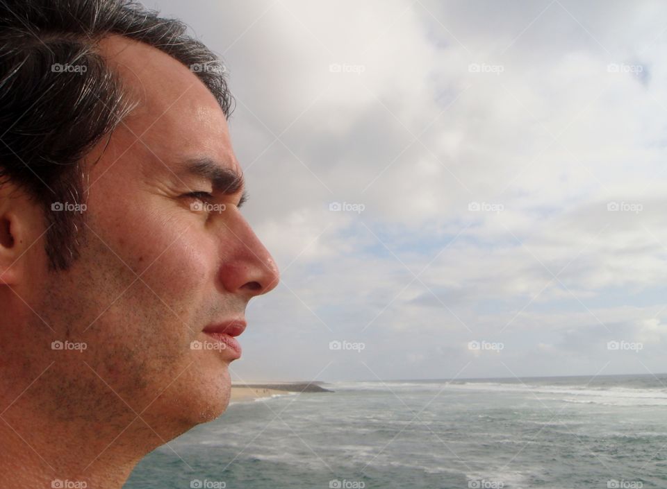 a man watching and listening to the see