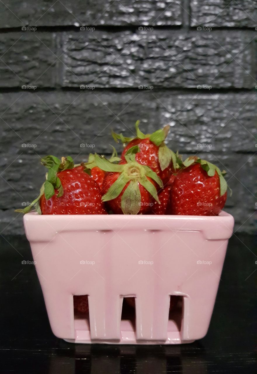 strawberries in a pink container