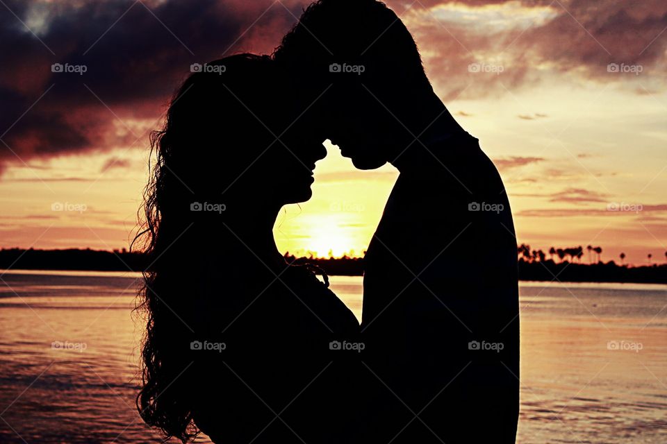 Silhouette of couple standing near sea