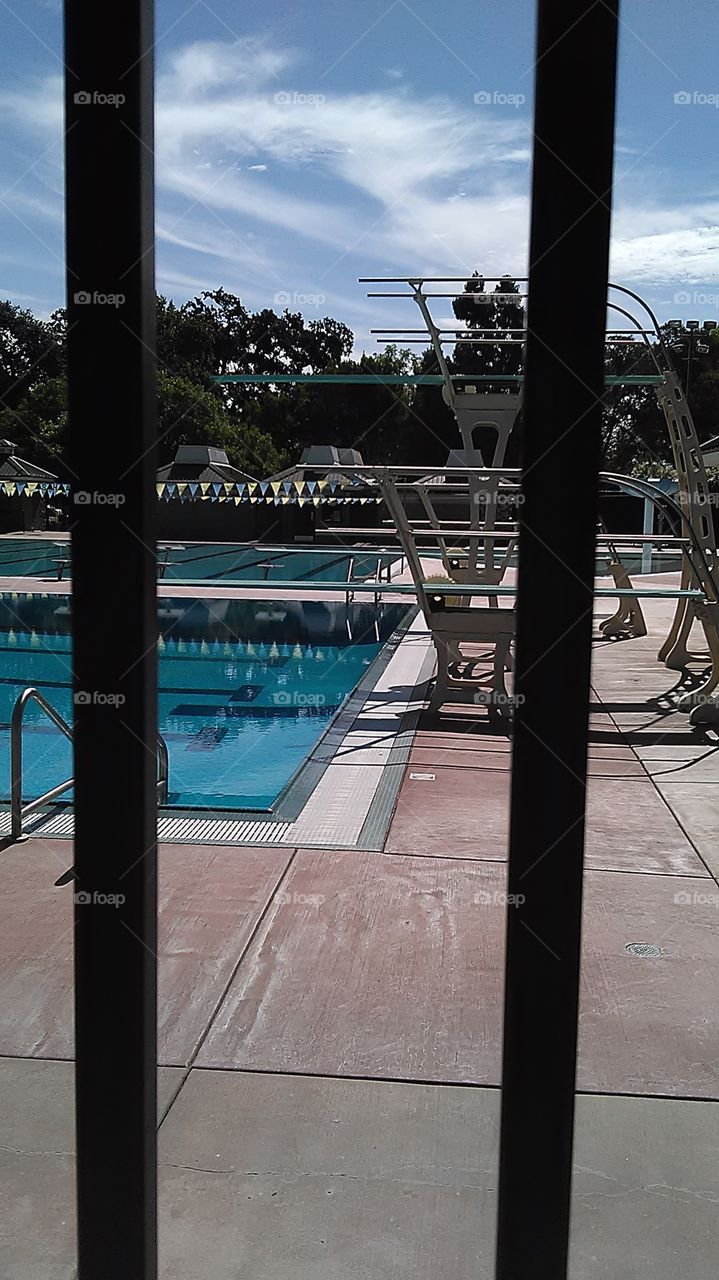 Fenced in diving board. Out at the park