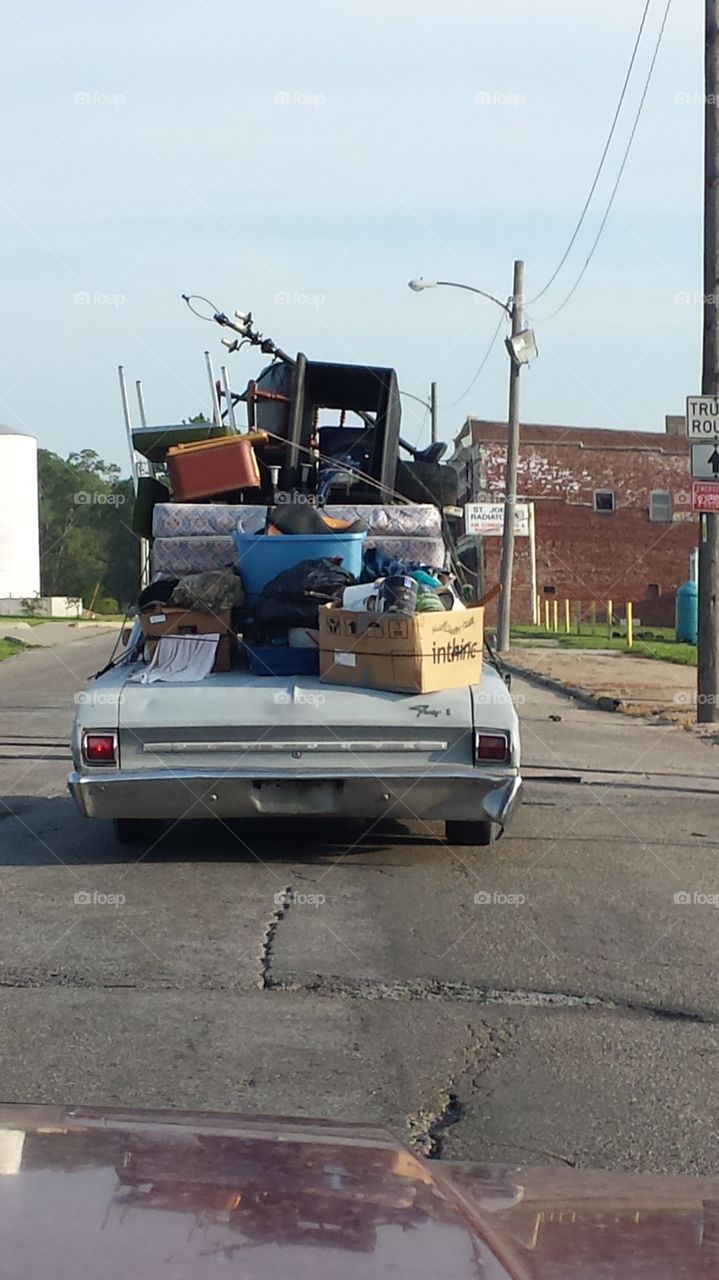 Moving Day. I ended up behind this jalopy and couldn't help but appreciate all of the stuff they could carry inside and outside of their car!