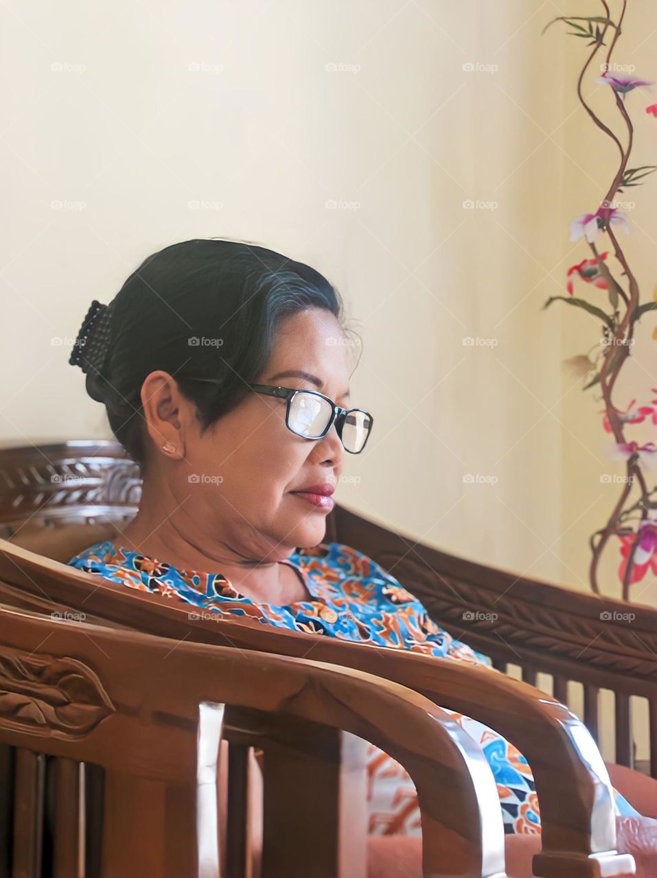 Woman sitting on chair at home