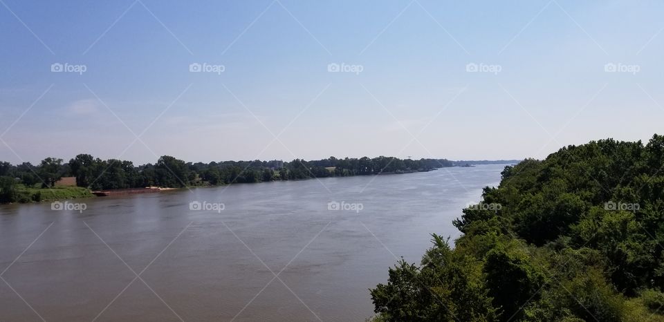 The Arkansas river running through Arkansas, taken from a bridge.